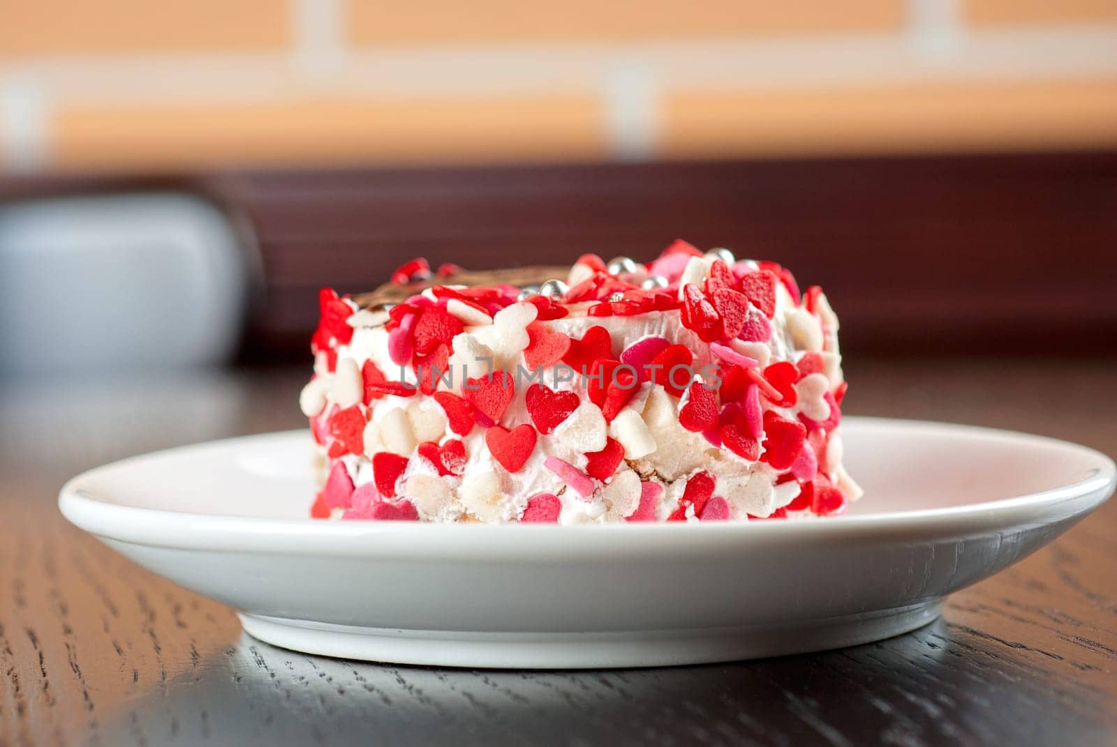 fresh baked cupcake with hearts on a wooden table