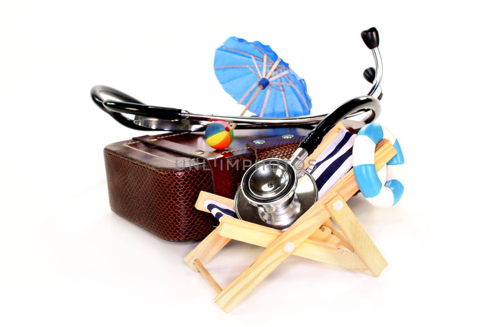 a suitcase,deck chair and stethoscope against white background