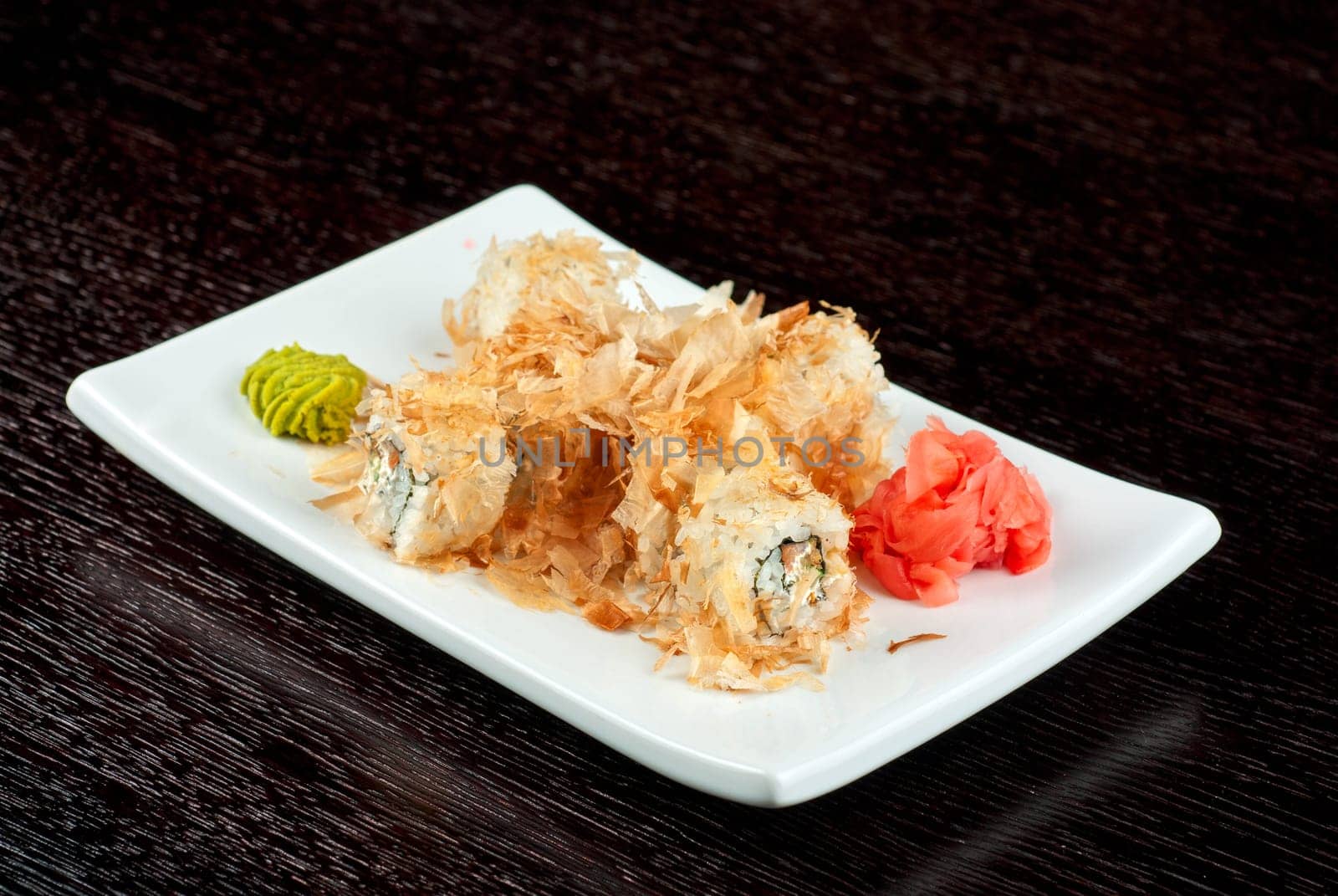 Sushi rolls of rice, nori, cream cheese, avocado, smoked salmon,cucumber and cuts of tuna