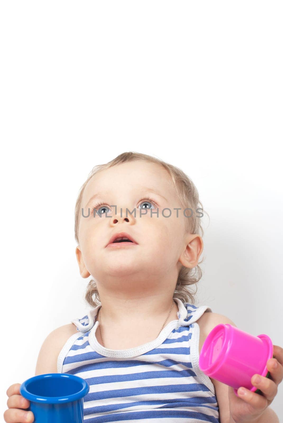 Small baby boy with a toy pyramid isolated on white