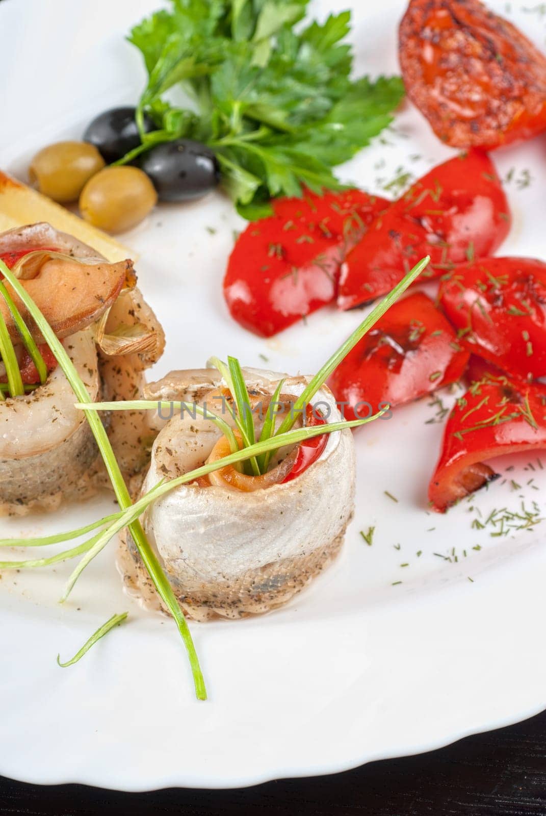 fillet of pikeperch stuffed with trout fish with baked pepper, tomato and leek