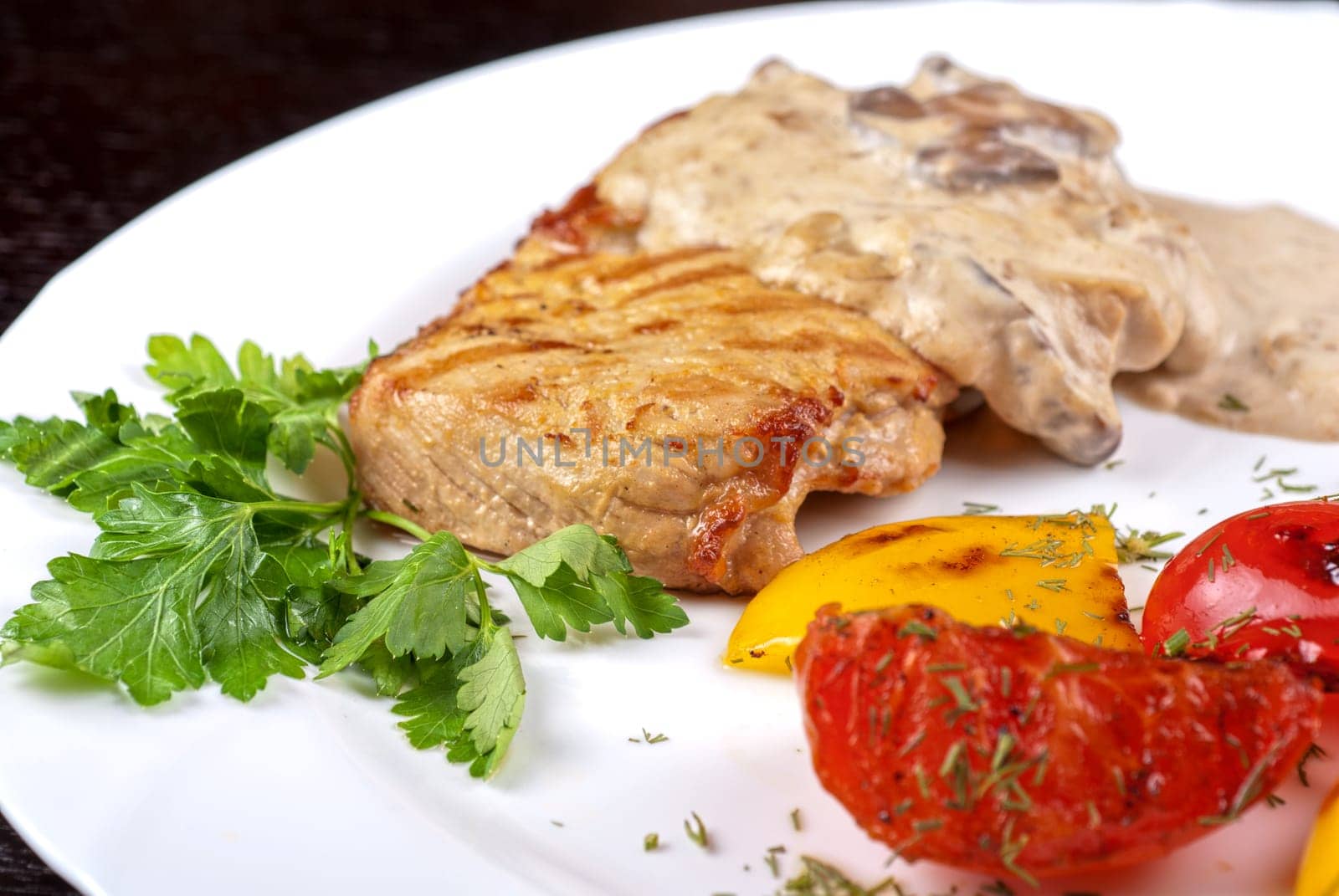 pork steak with mushroom sauce and grilled vegetables