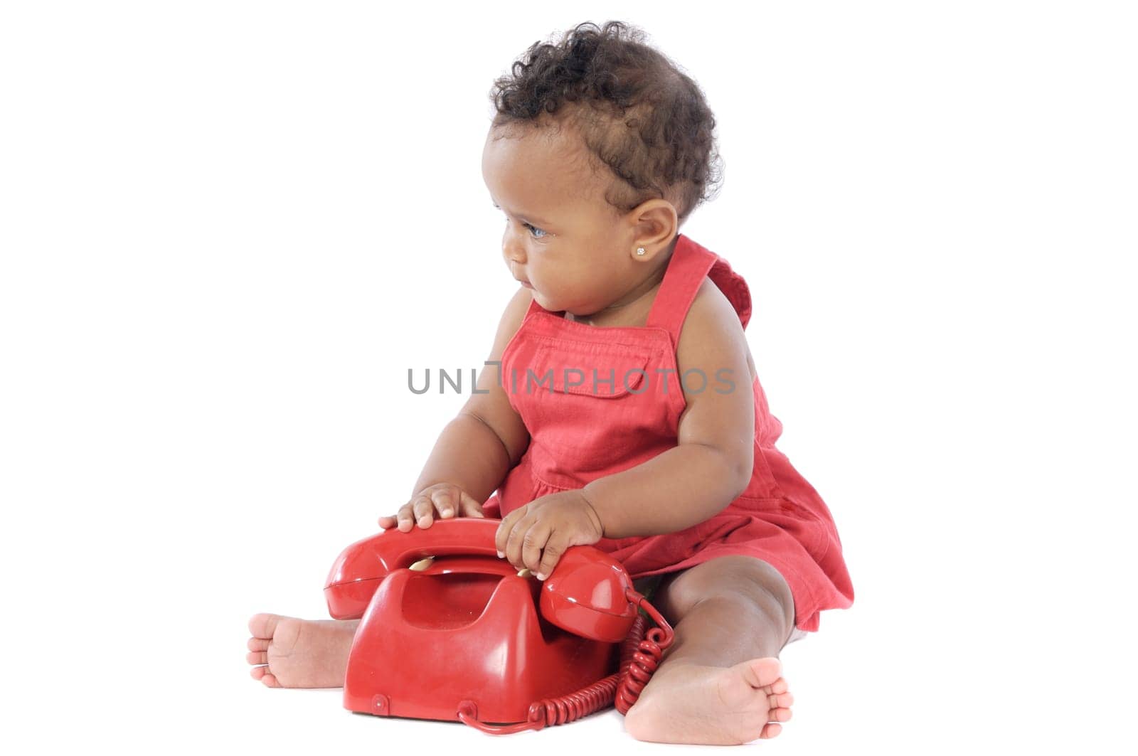 Baby with red phone a over white background