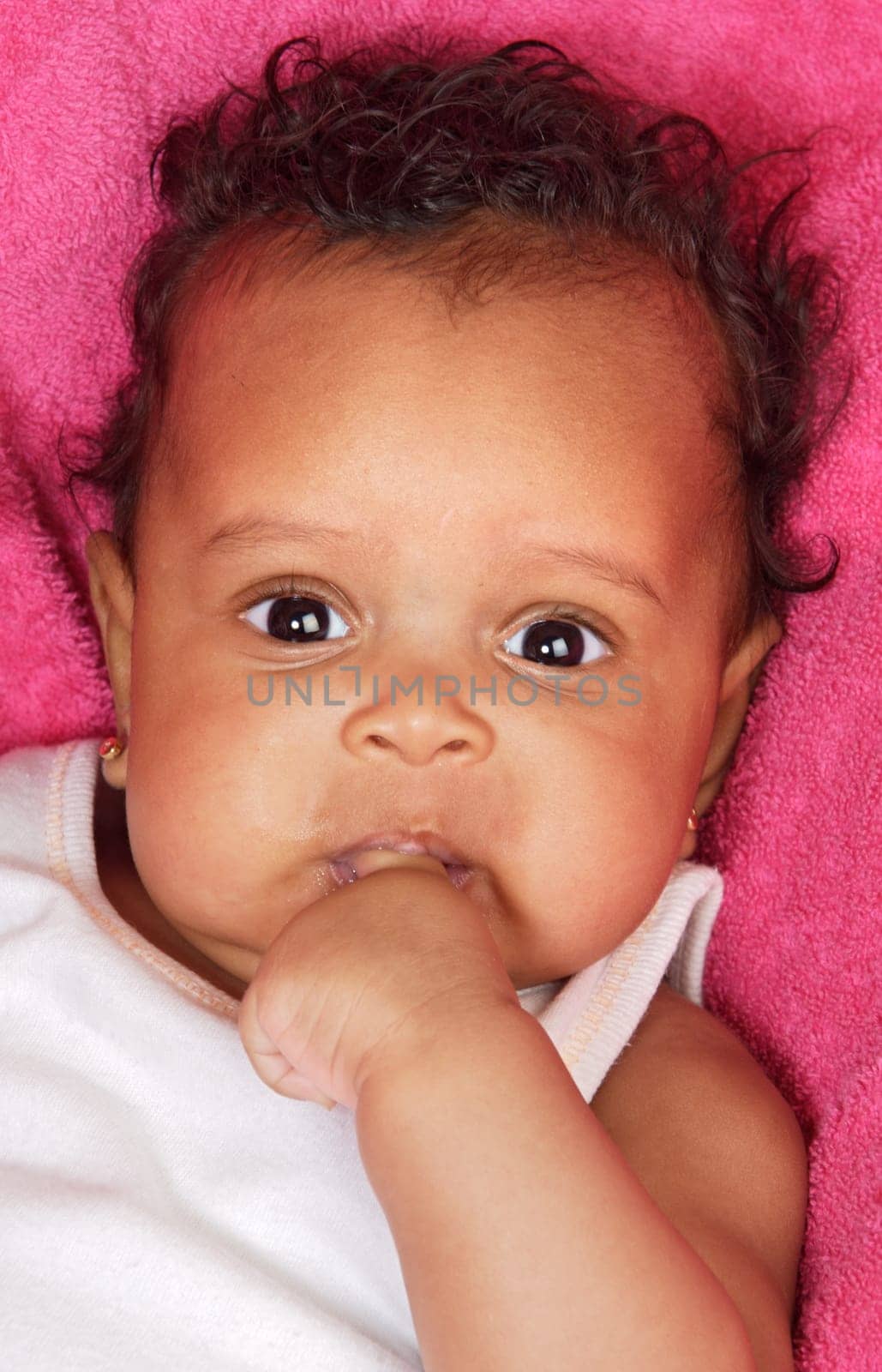 lovely and beautiful baby on a pink towel
