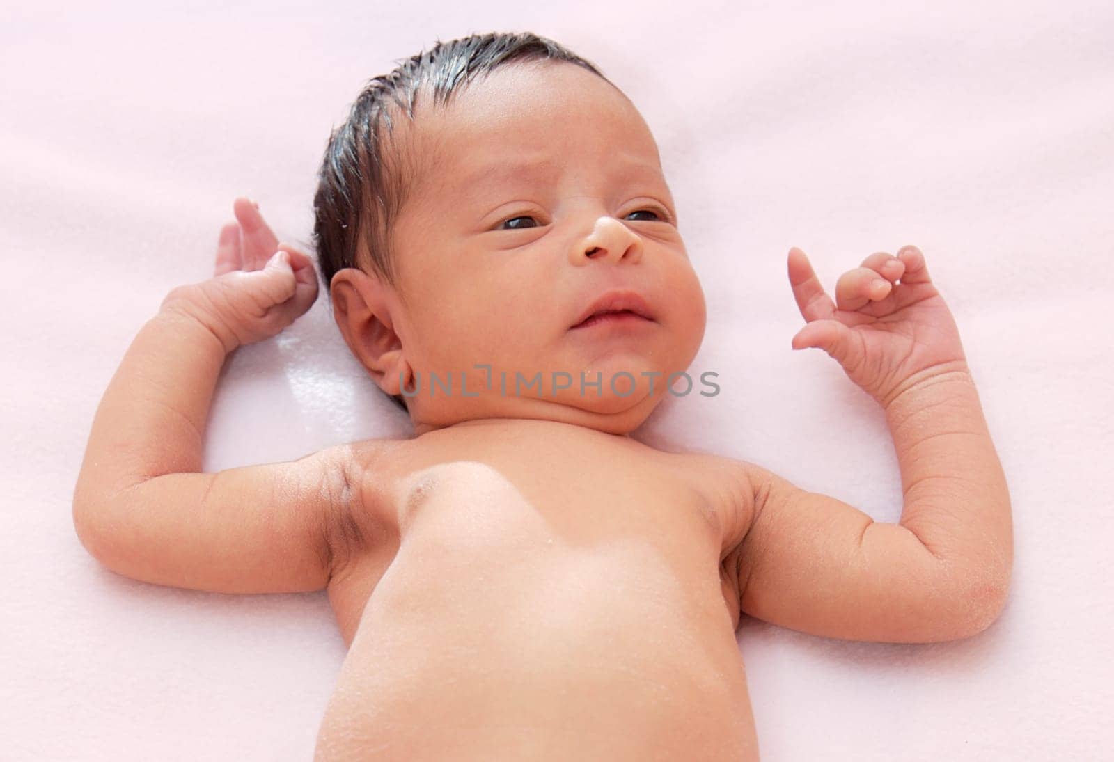 lovely and beautiful baby on a pink towel