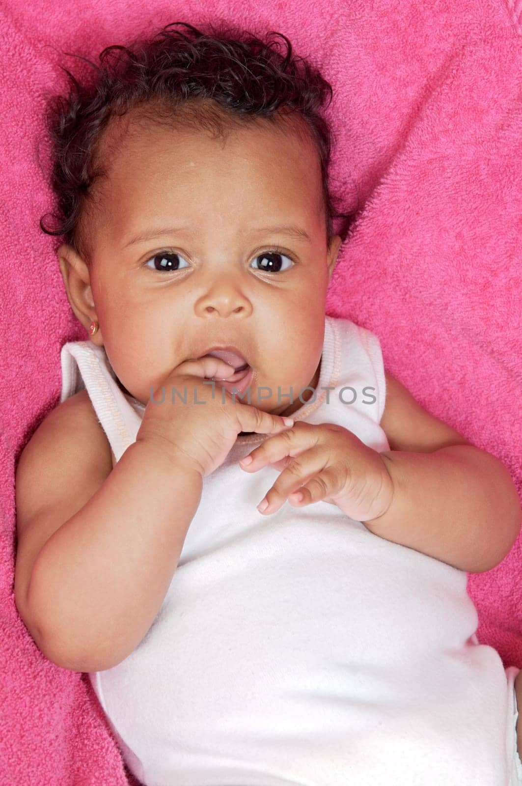 lovely and beautiful baby on a pink towel