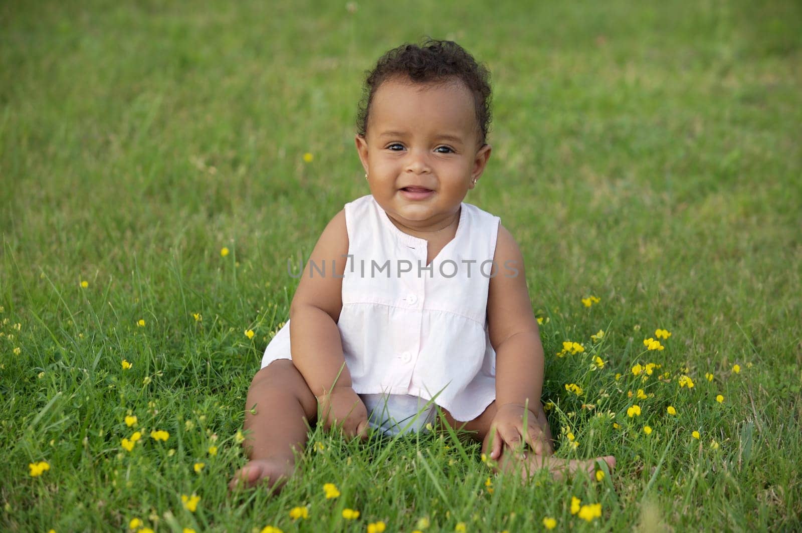 adorable happy baby on the green grass