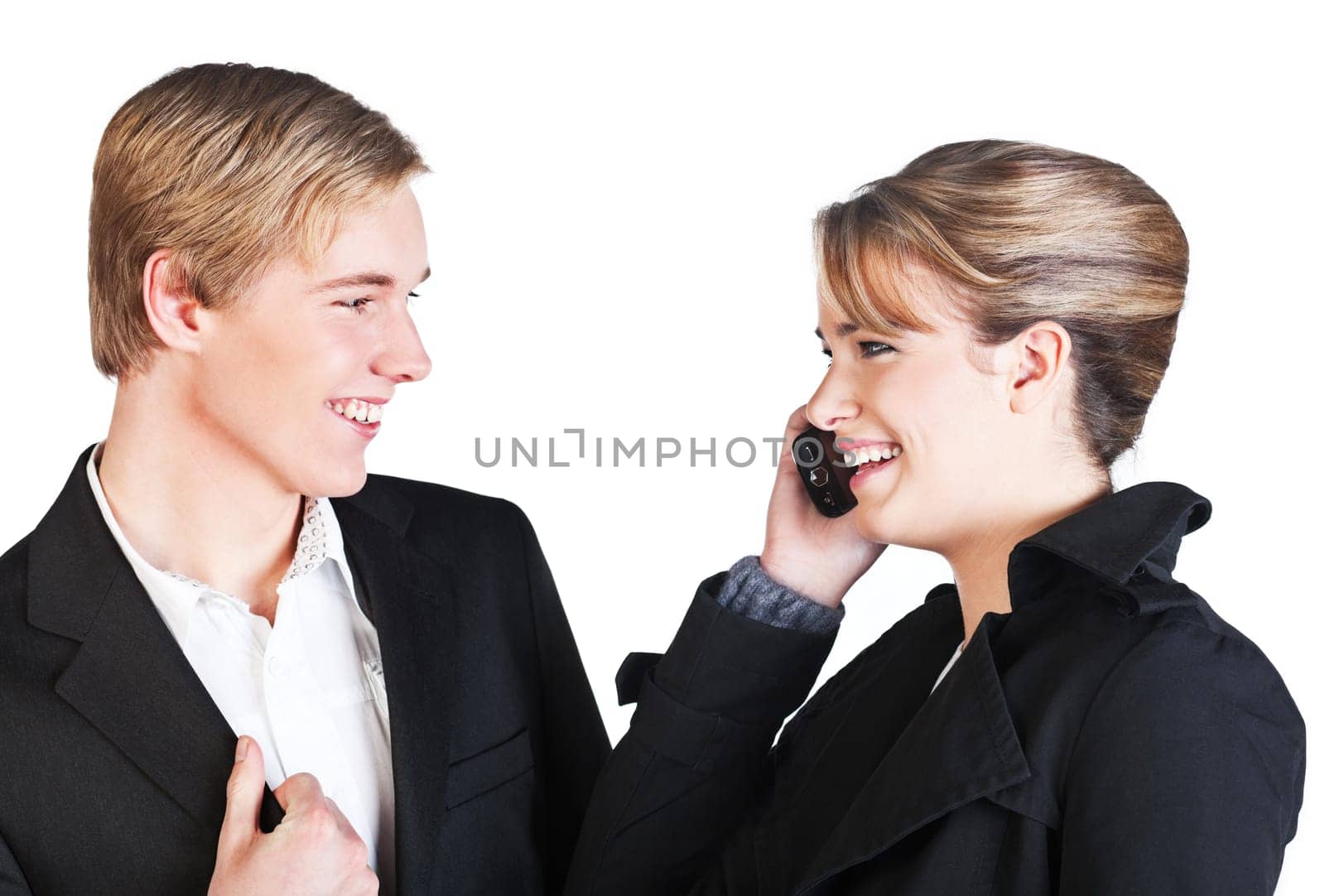 Young smiling woman with cellphone and young smiling man  isolated on white