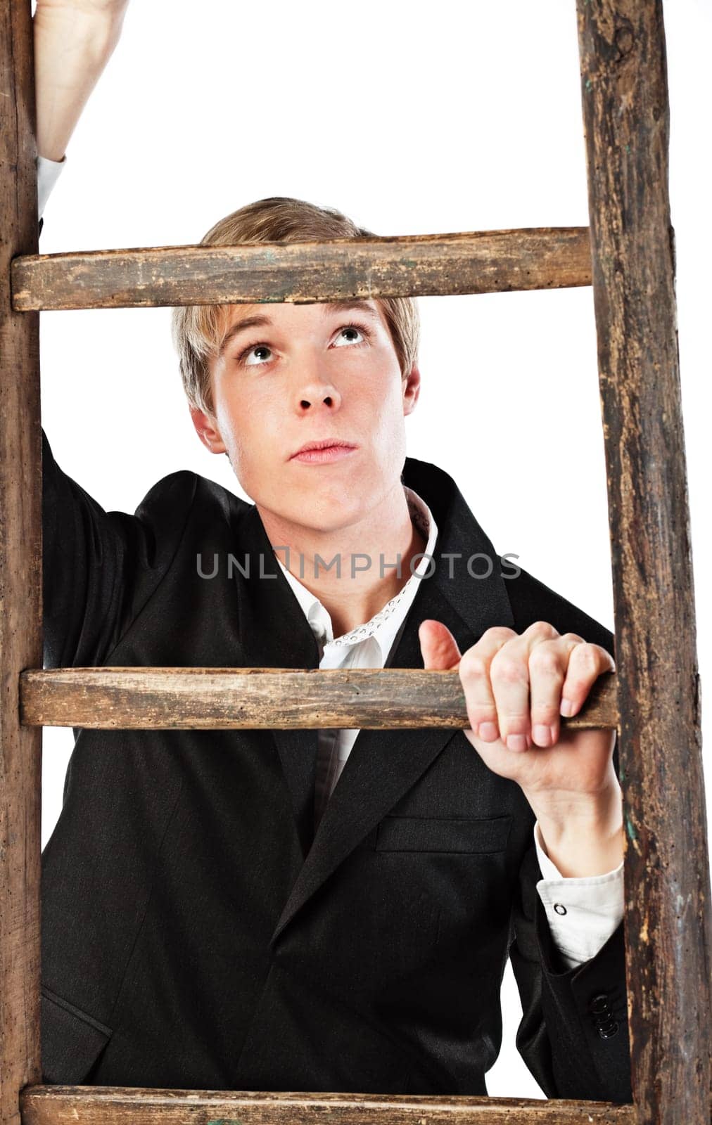 Young blond handsome man climbing wooden ladder