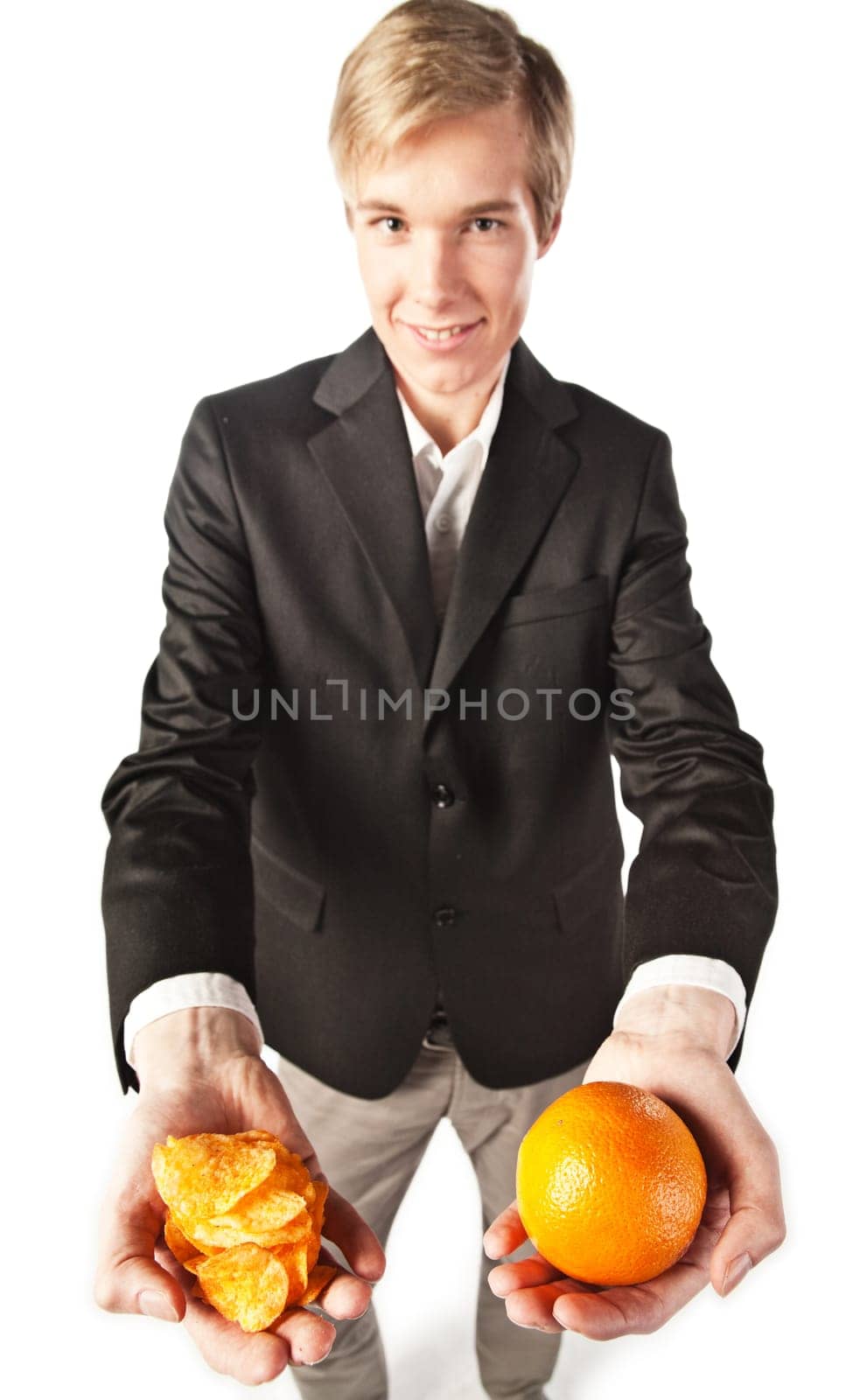 Smiling young man offering a choice between healthy and unhealthy eating