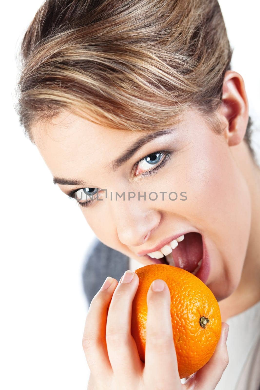 Portrait of pretty smiling young blond woman holding an orange  isolated on white