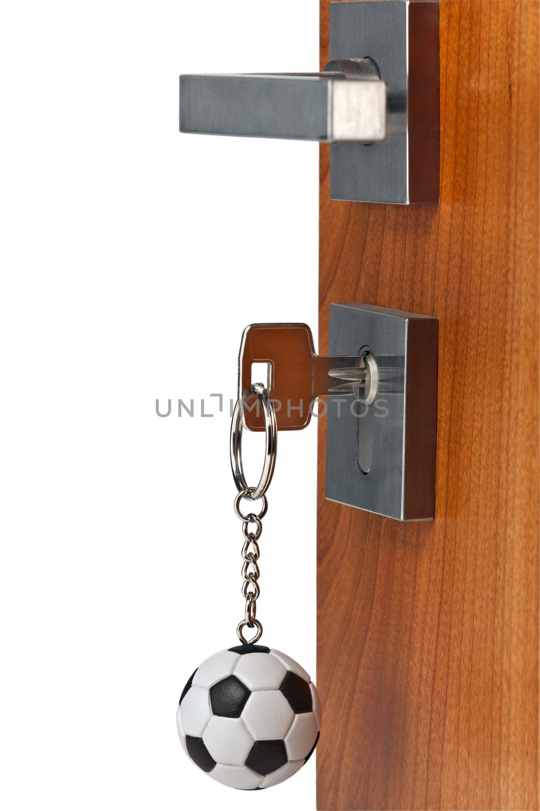 Door open with keys in lock and soccer ball key chain,isolated with clipping Path inclusive