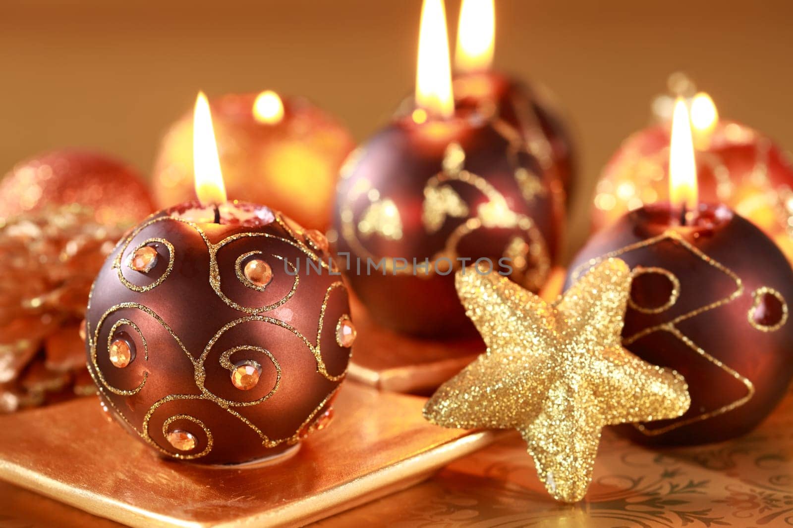 Christmas still life with candles and jingle bells in brown and golden tone