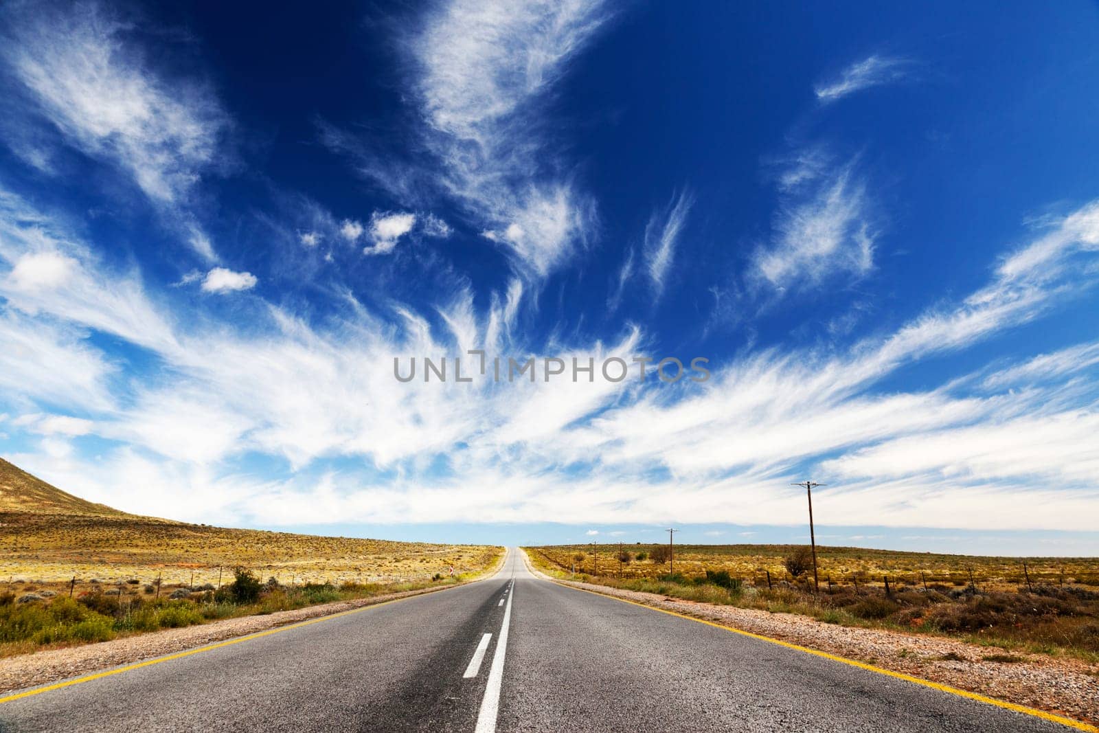 Endless,lonely road or highway that runs towards the horizon.
