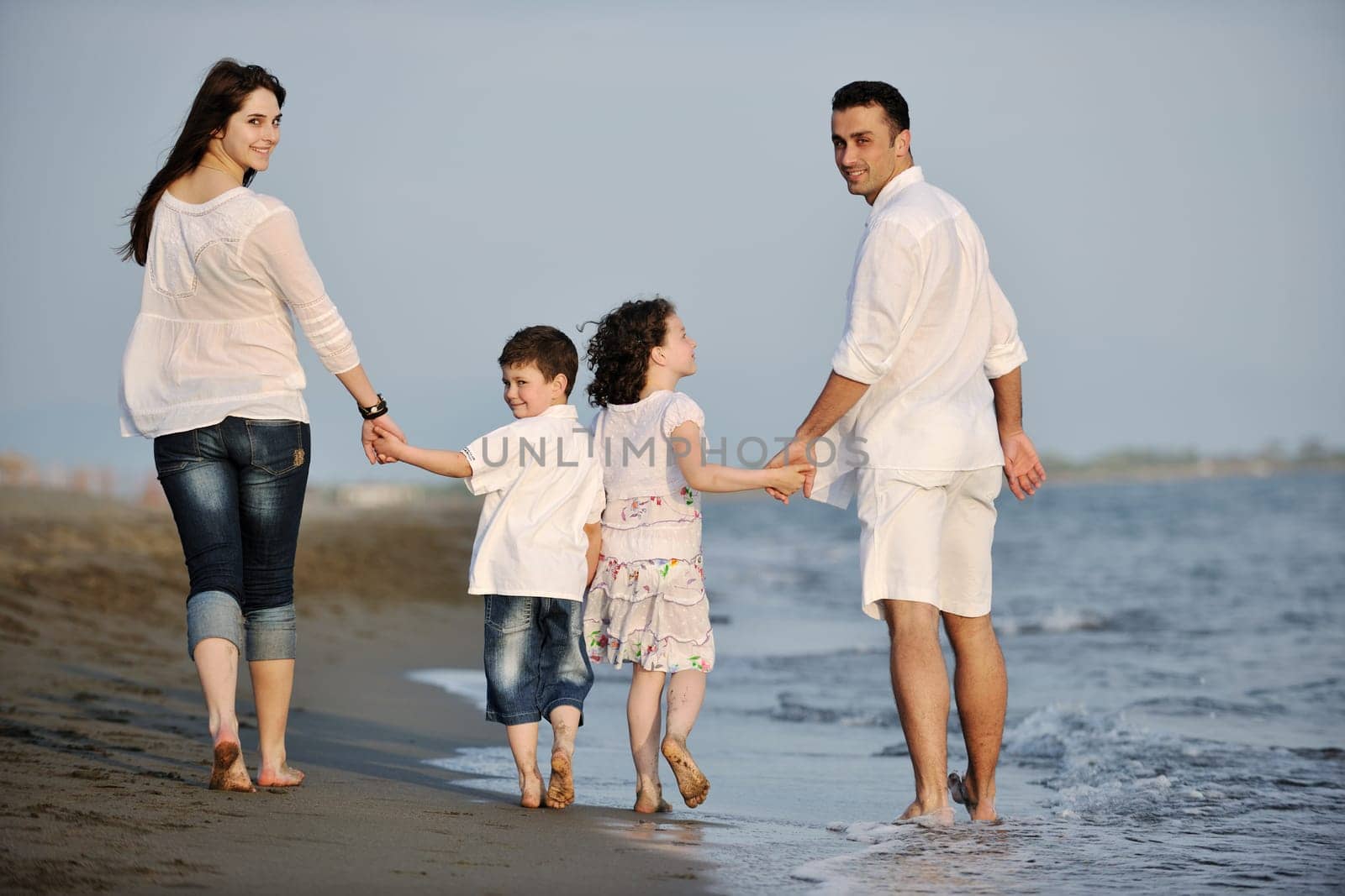 happy young family have fun and live healthy lifestyle on beach