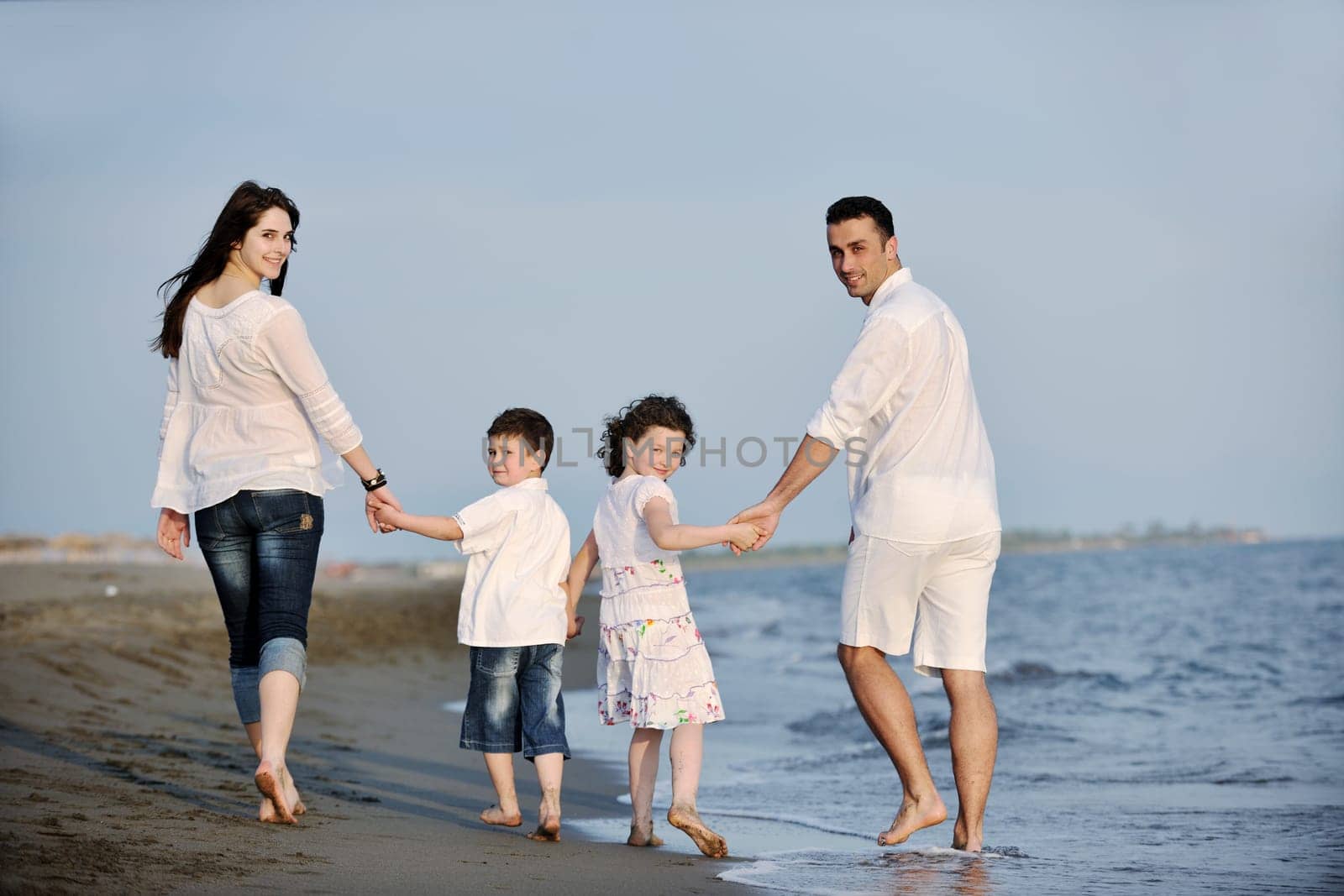 happy young family have fun and live healthy lifestyle on beach