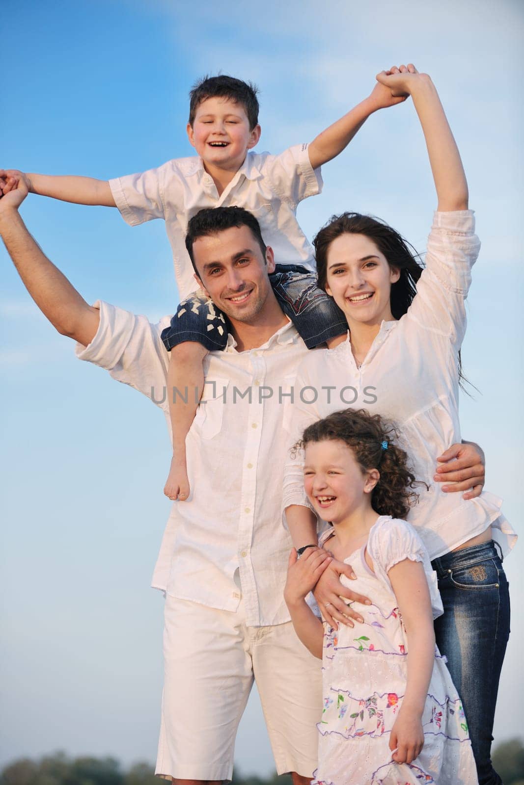 happy young family have fun and live healthy lifestyle on beach