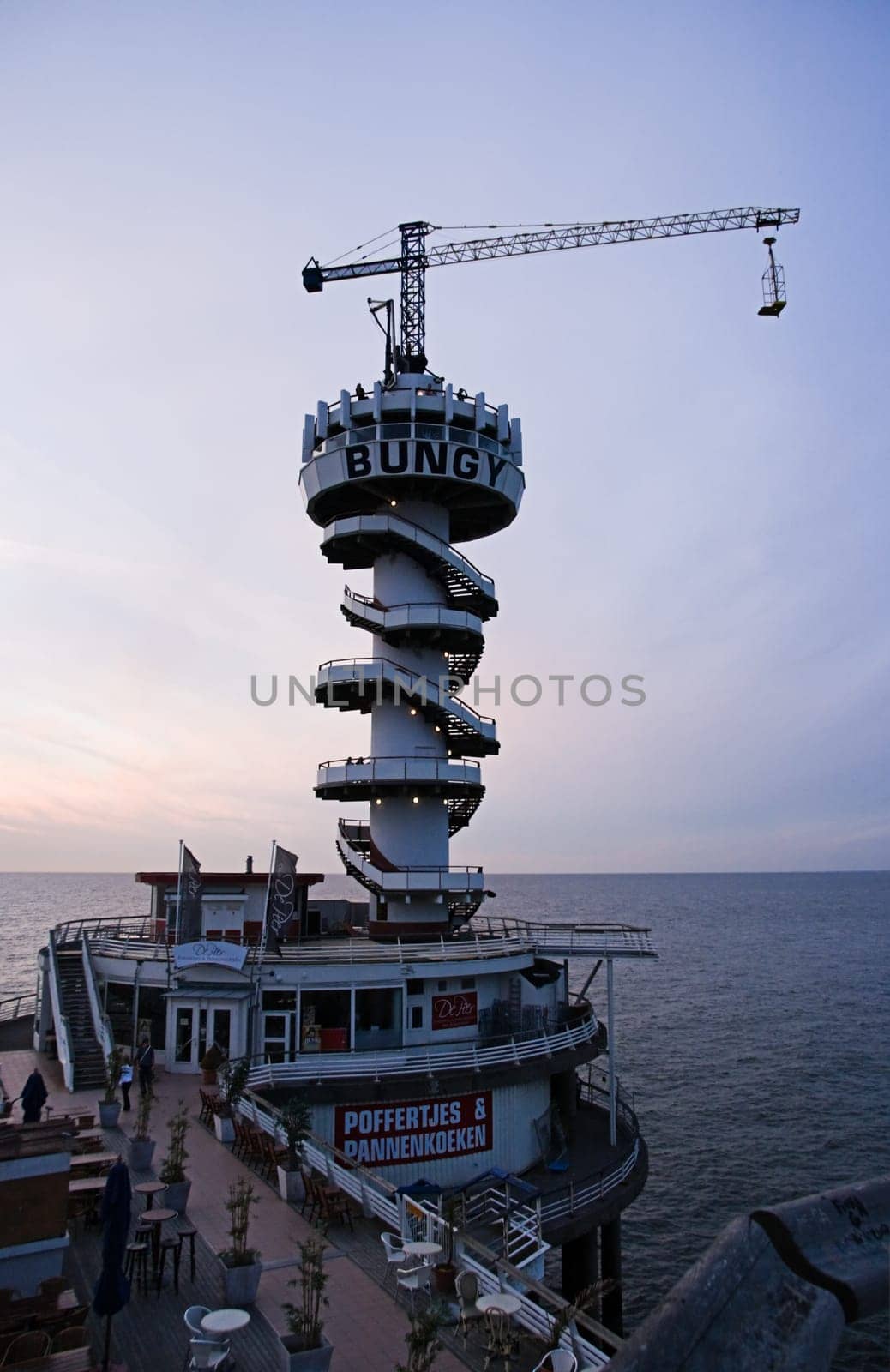 SCHEVENINGEN -THE NETHERLANDS-JULY 2007-Bungyjumping on the pier at sunset