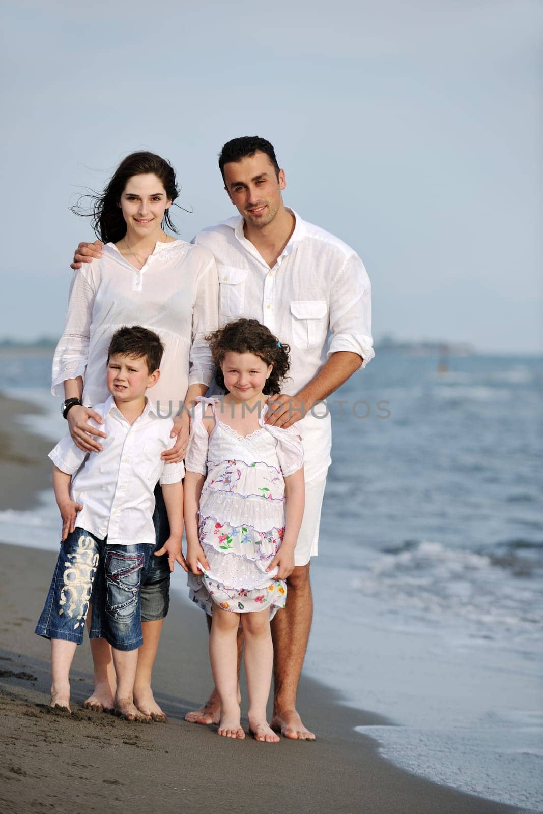 happy young family have fun and live healthy lifestyle on beach