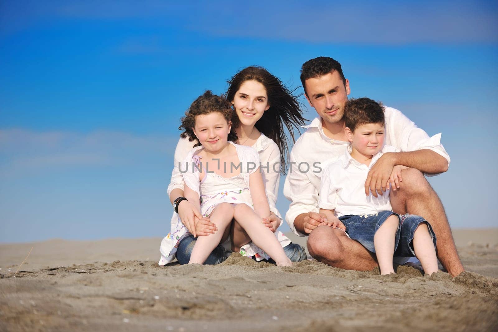 happy young family have fun and live healthy lifestyle on beach
