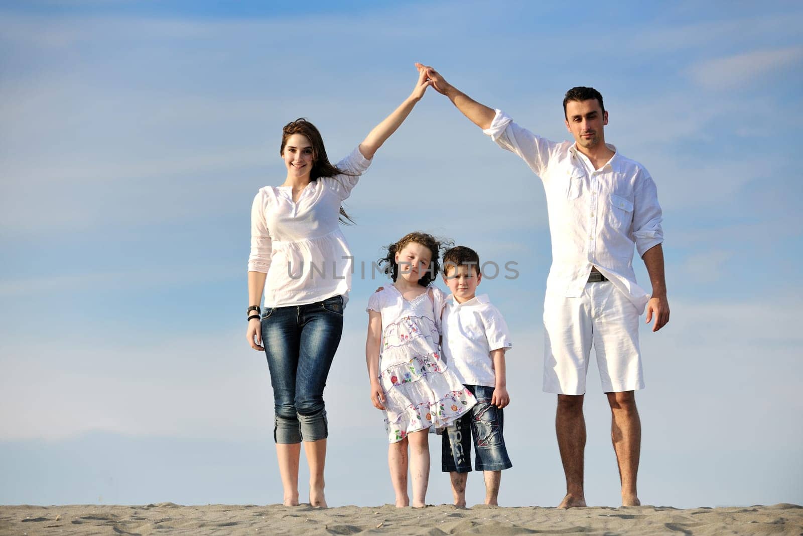 happy young family have fun and live healthy lifestyle on beach