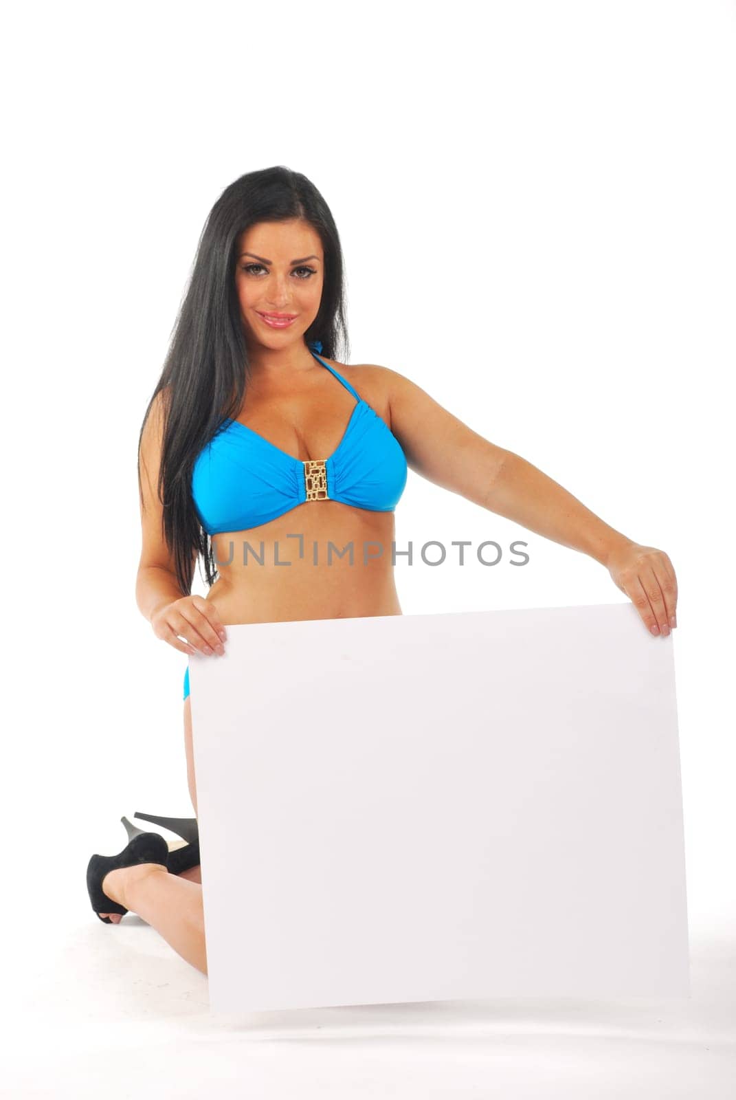 Pretty girl kneeling with blank notice board