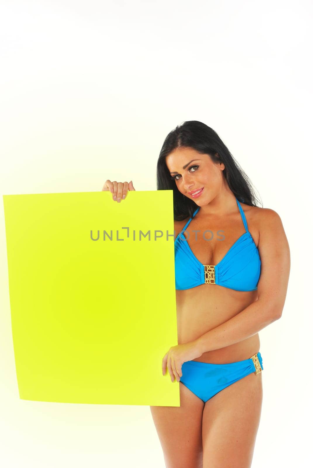 pretty girl holding bright yellow sign
