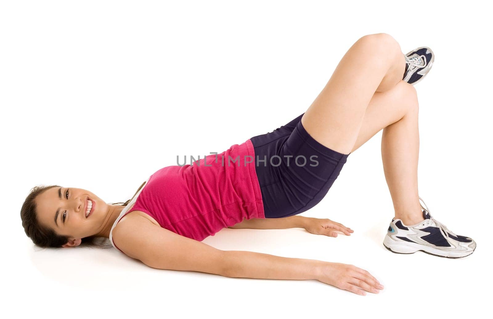 A young beautiful brunette is exercising and stretching.