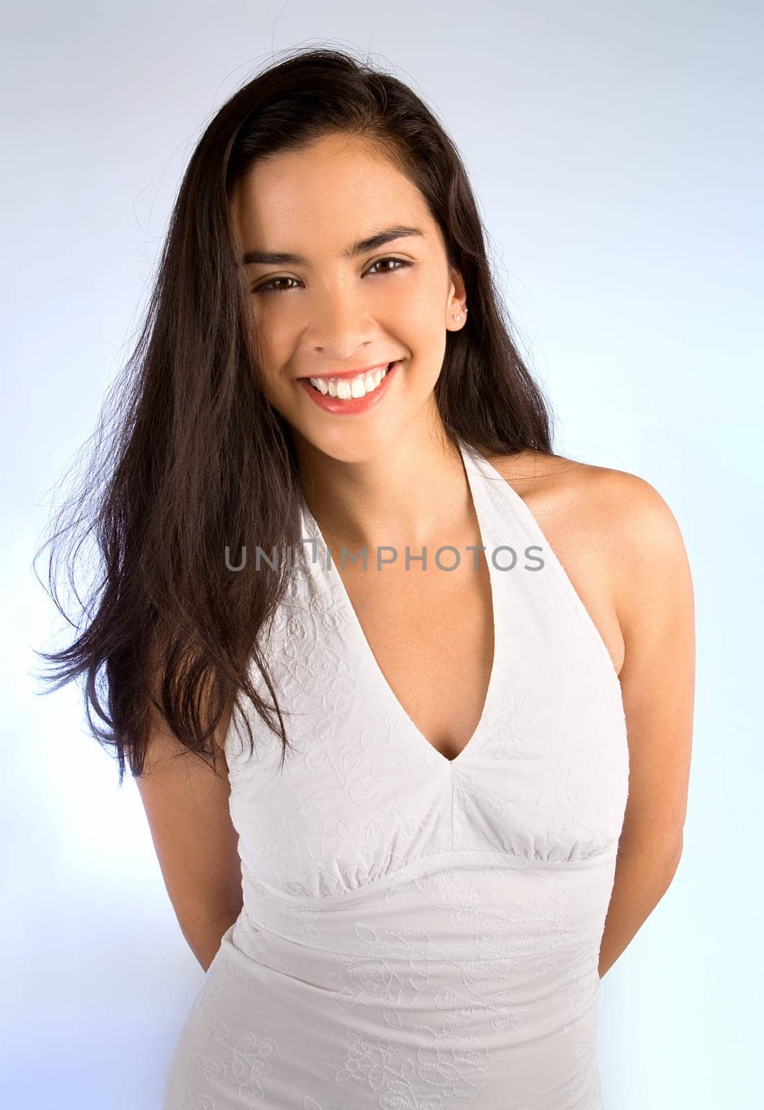 Beautiful young woman is smiling at the camera.