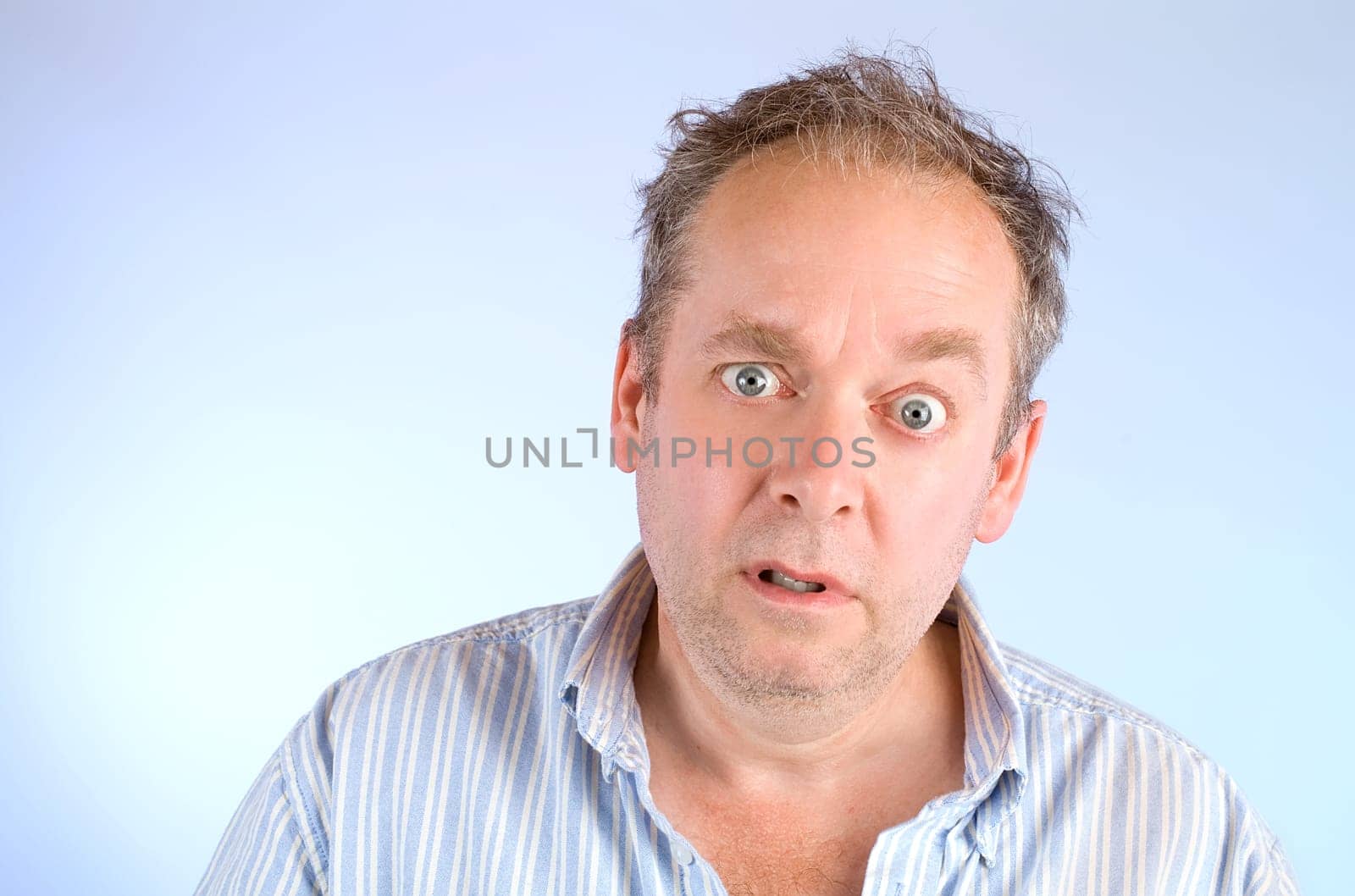 Serious and scruffy looking man posing and looking at the camera