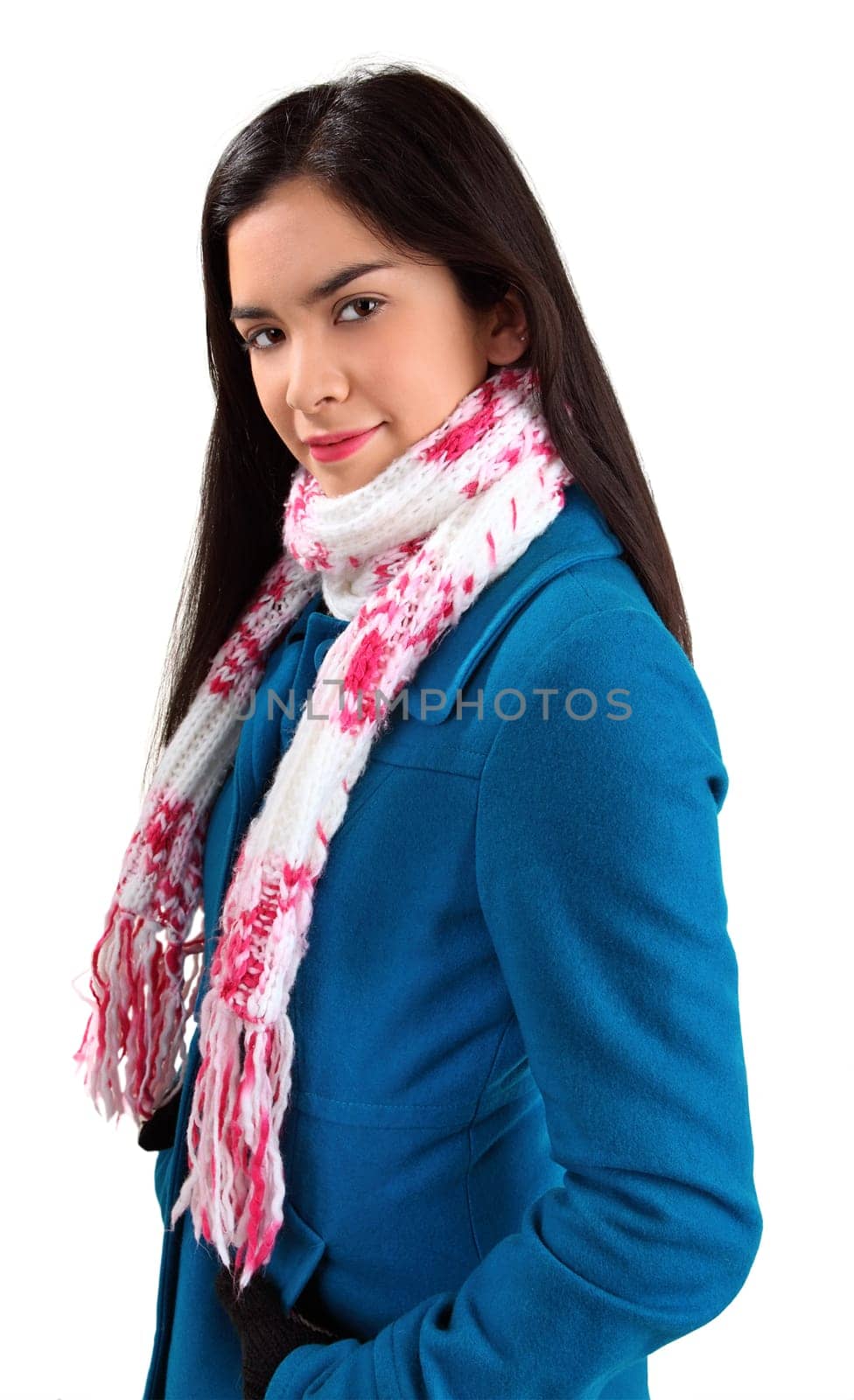 A beautiful young woman wearing a scarf and a winter coat is looking at the camera.