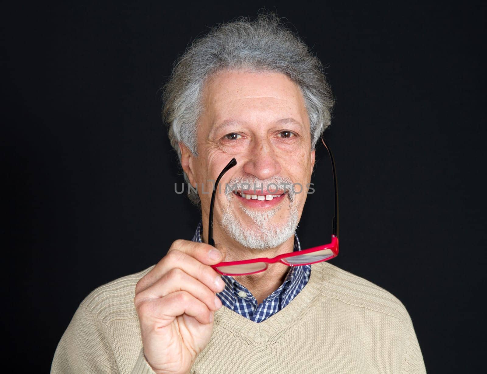 Portrait of a happy mature man isolated on black background