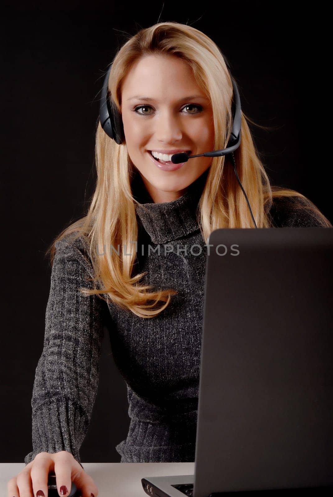 Lovely blond business woman working at laptop computer