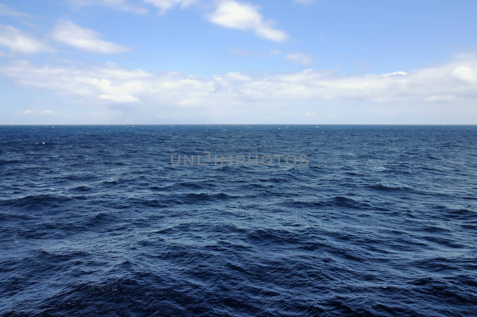 Open blue sea deep water and sky horizon background.