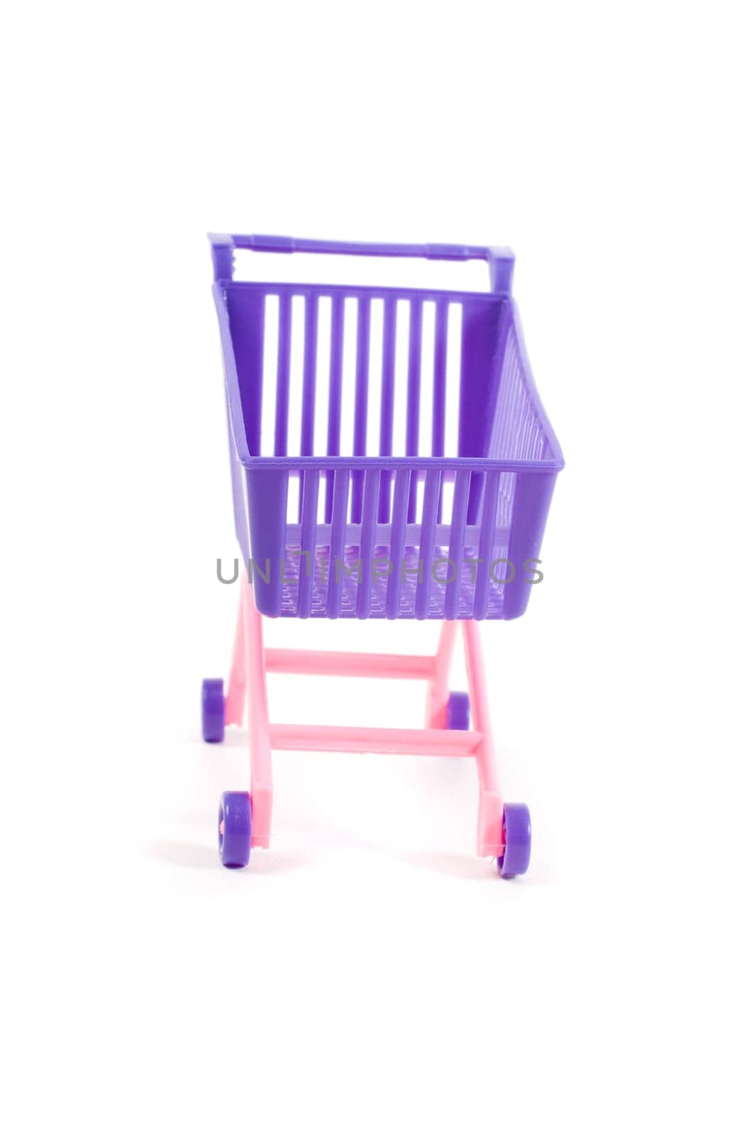 Conceptual photo with miniature shopping-cart isolated on white