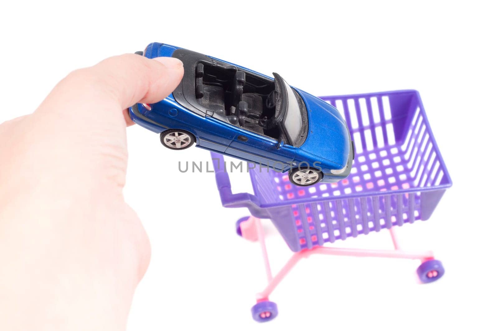 Conceptual photo with car and shopping-cart isolated on white