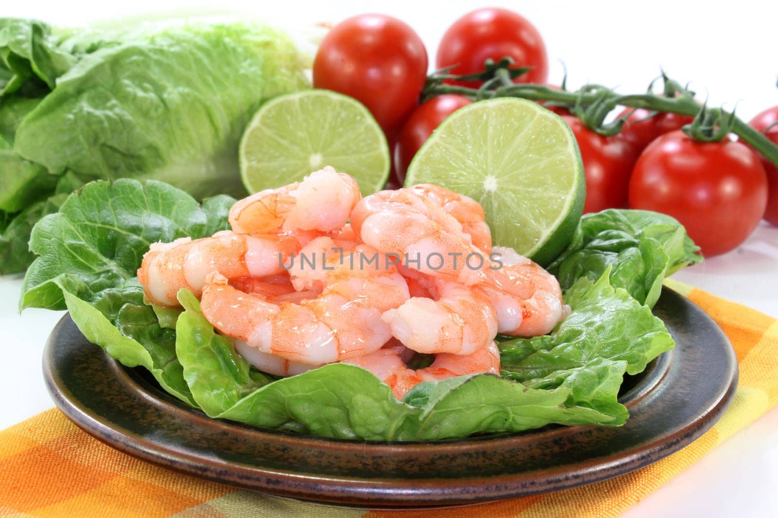 fresh prawns and lime against white background