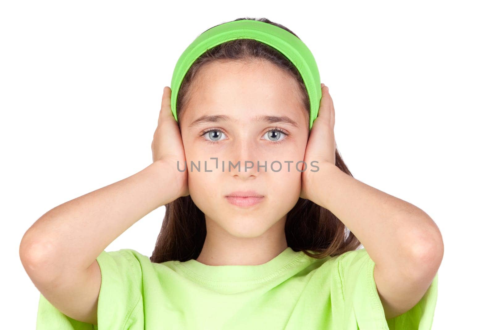 Frightened girl with ears plugged isolated on a white background