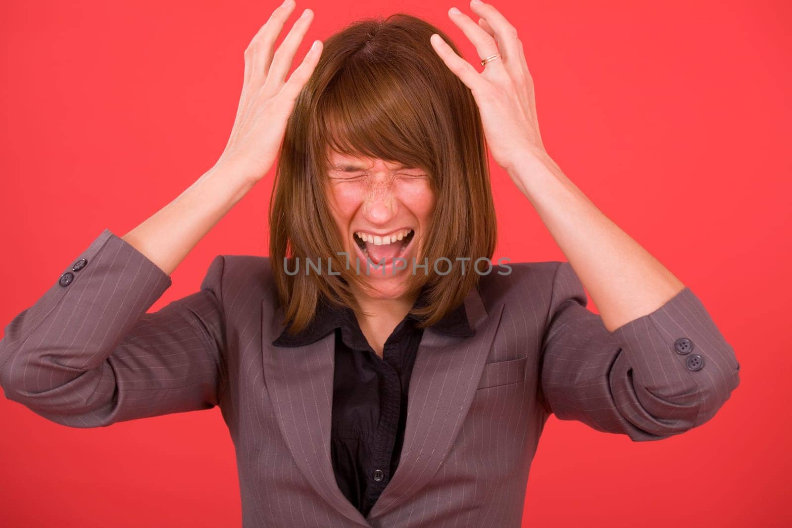angry woman screaming out loud over red background