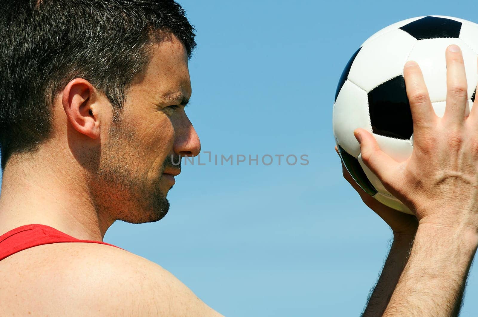 attractive football player with black and white balloon