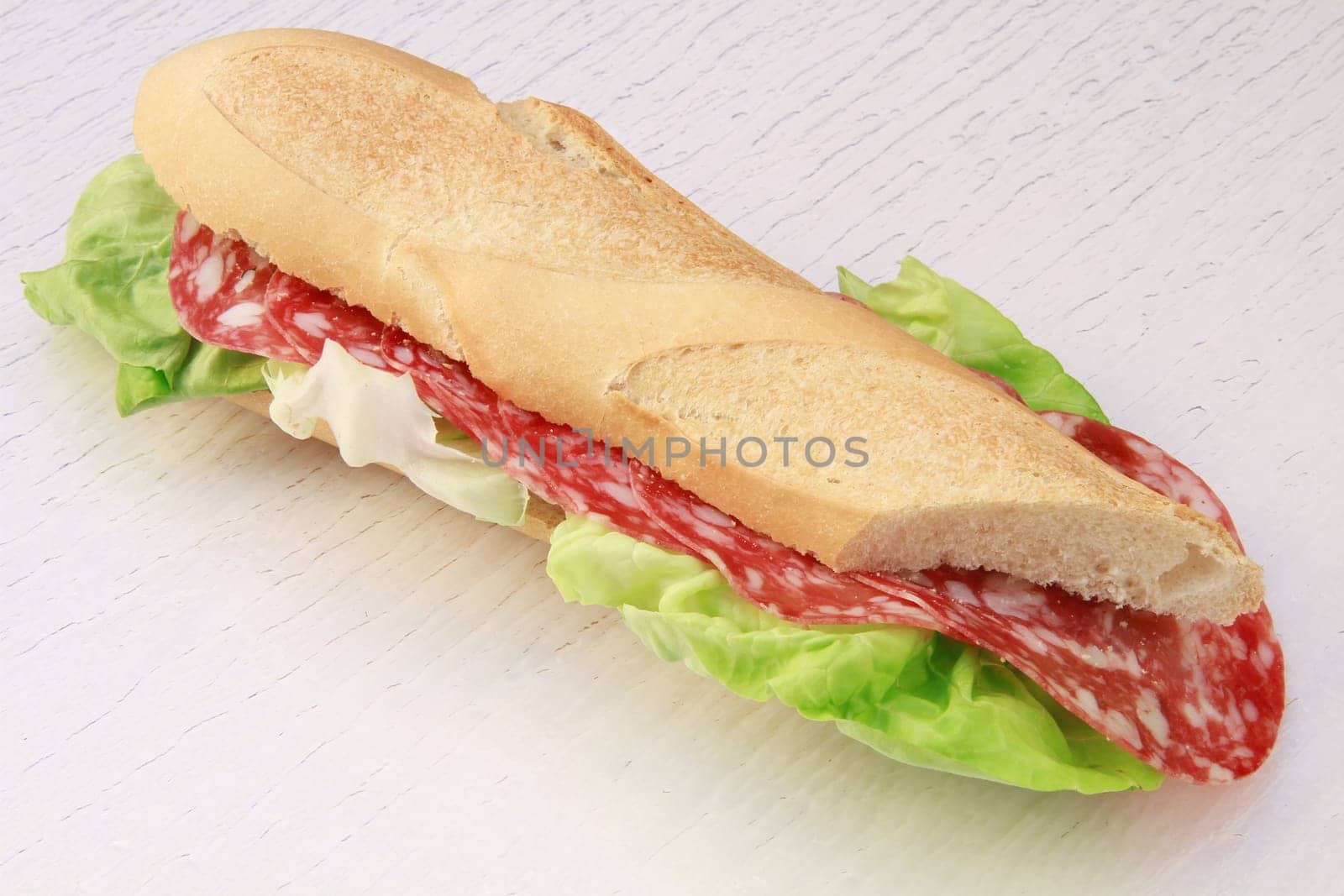 a salami roll with lettuce