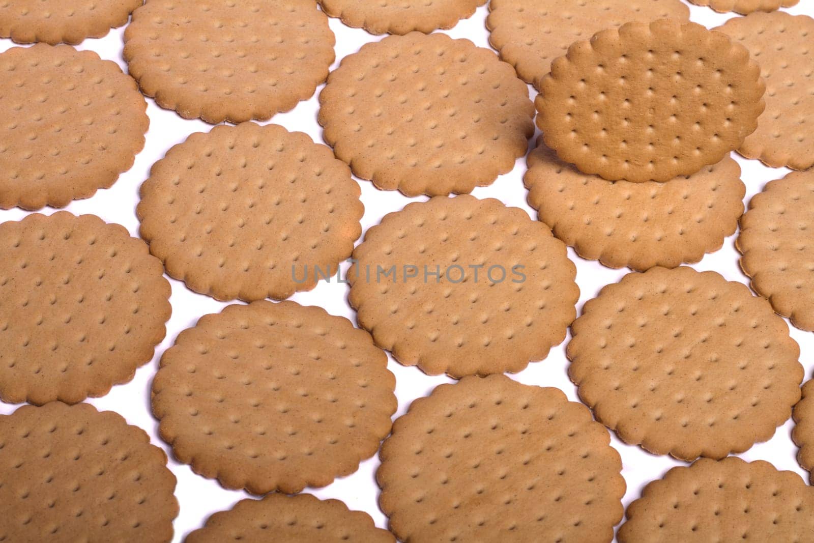View of many round biscuits isolated on a white background.
