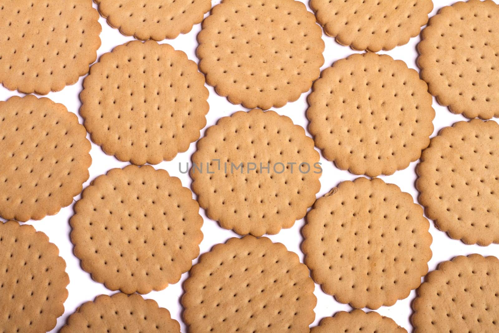 View of many round biscuits isolated on a white background.