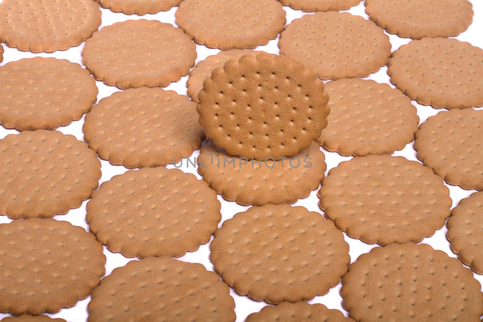 View of many round biscuits isolated on a white background.