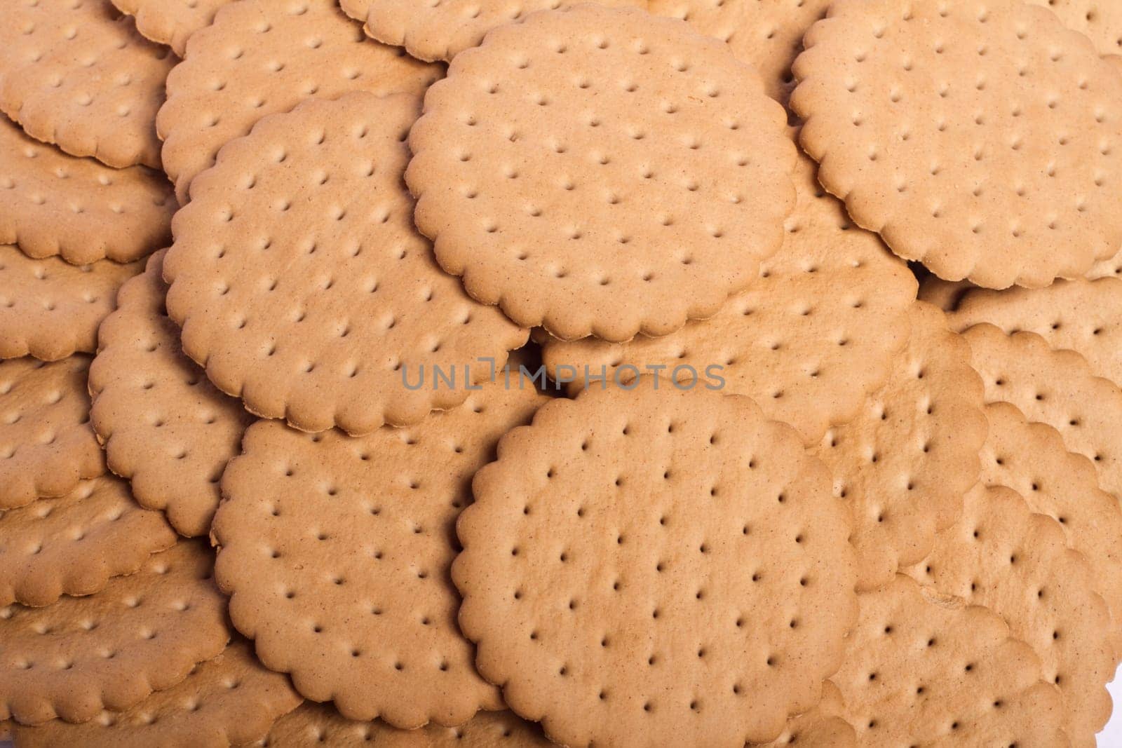 View of many round biscuits stacked on top of each other.