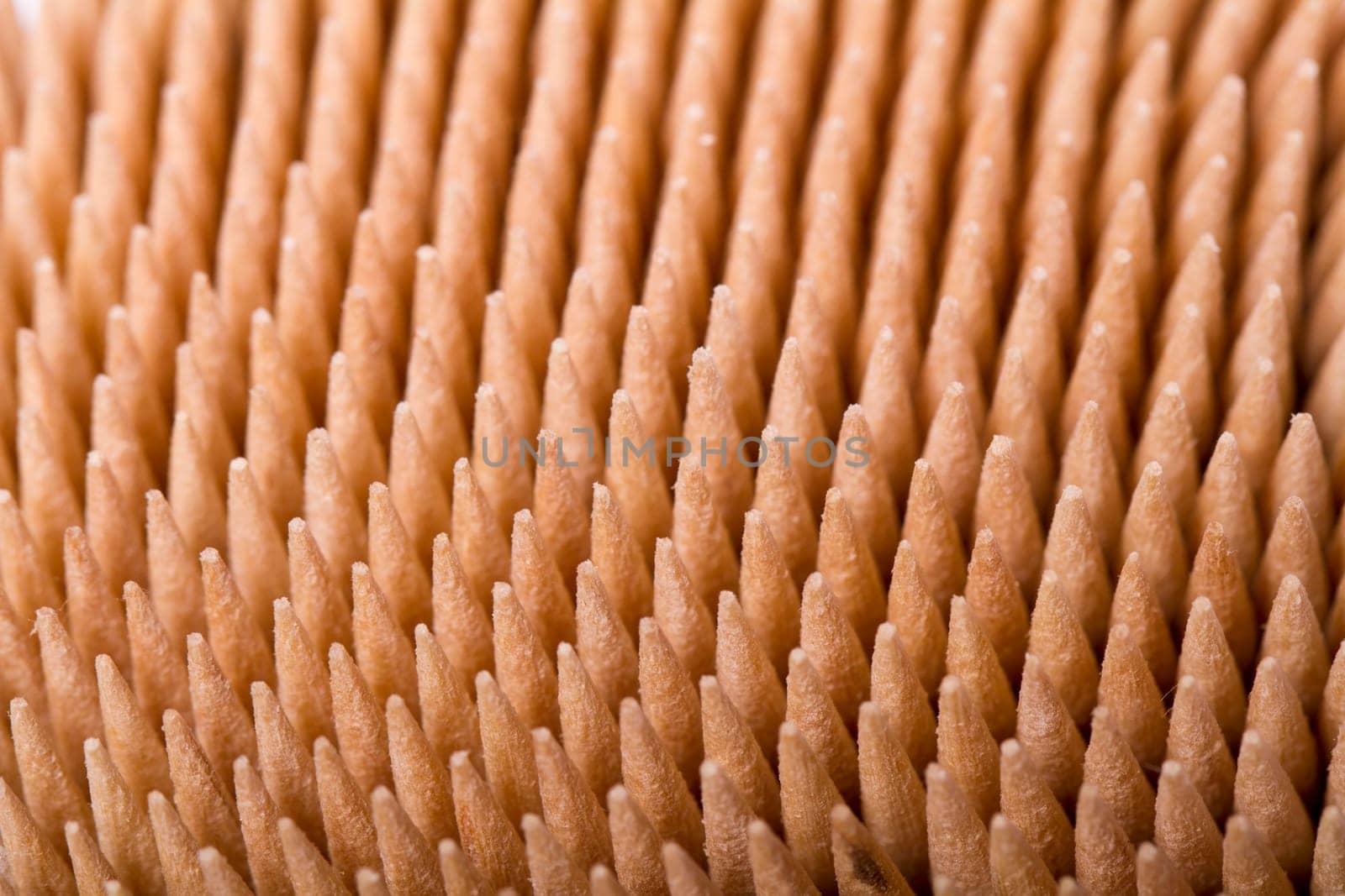 Macro view of a bunch of toothpicks inside a container.