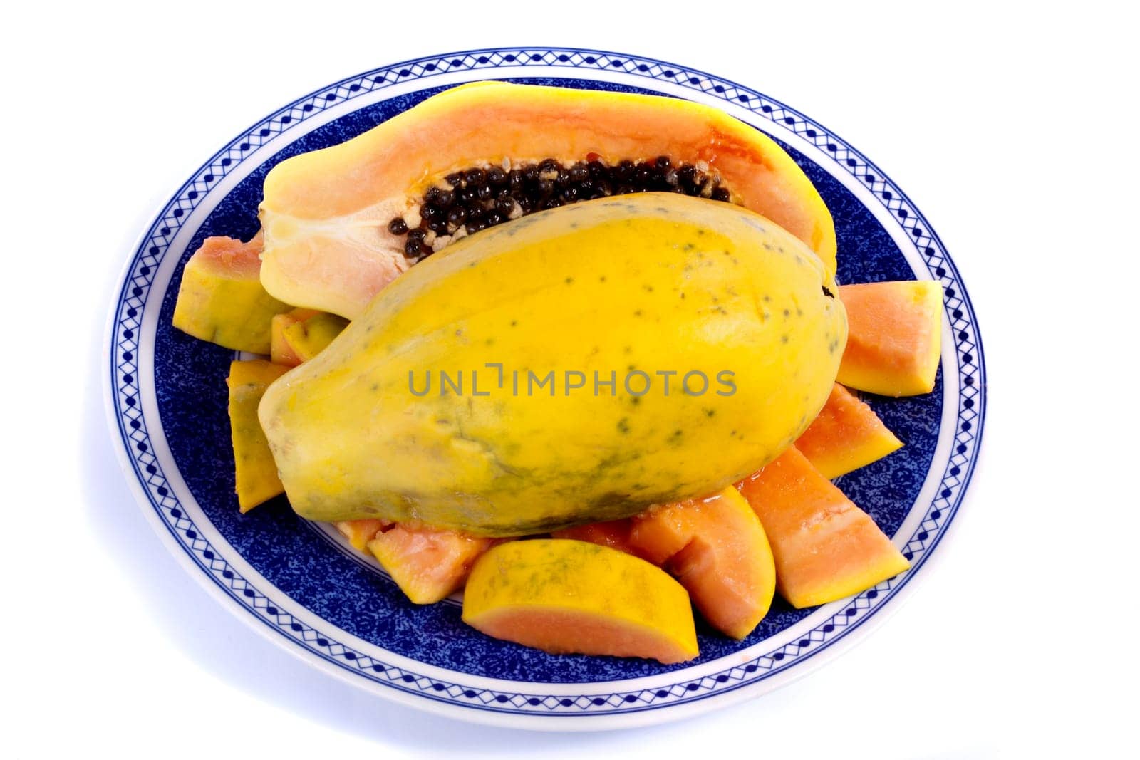 Close up view of papaya fruit sliced presented on a dish.