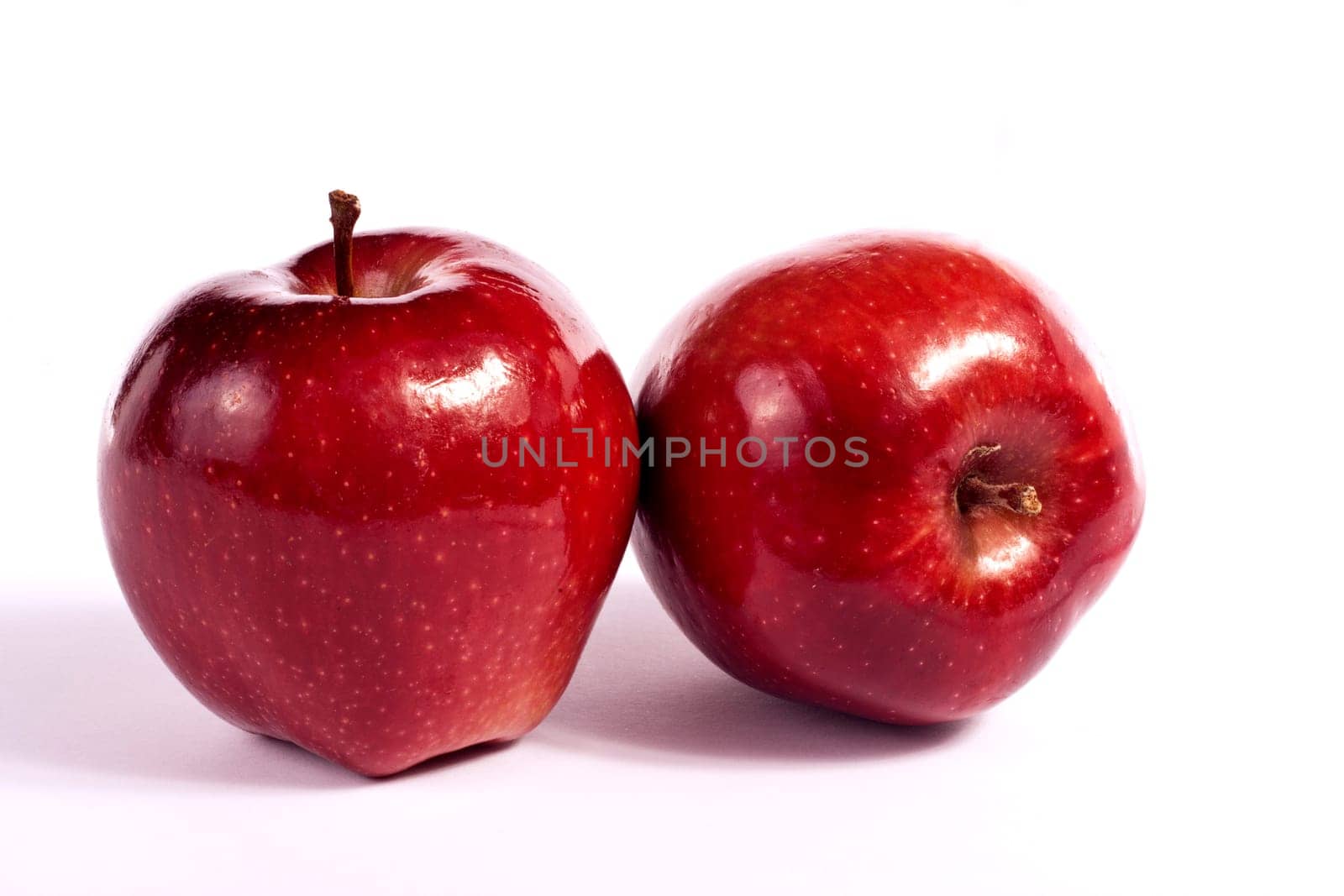 Close up view of some red apples isolated on a white background.