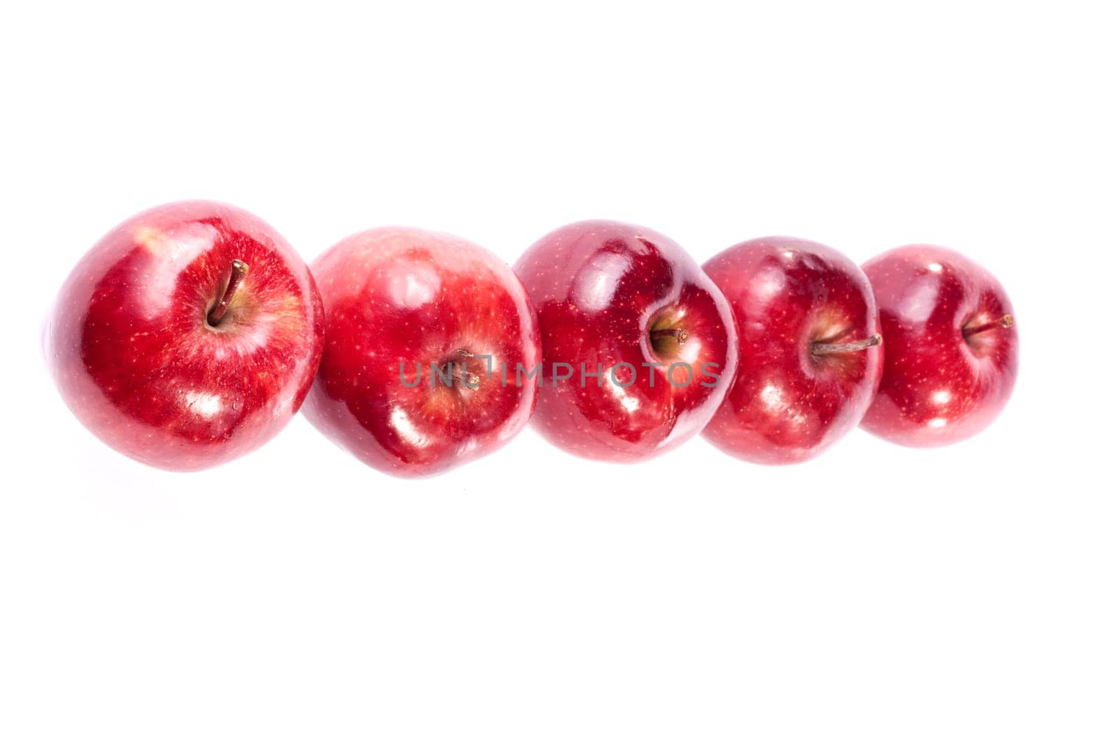 Close up view of some red apples isolated on a white background.