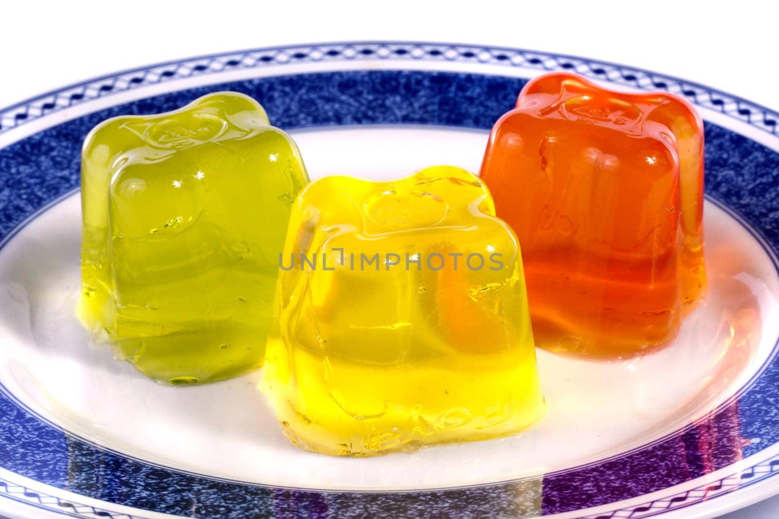 Close up view of several colorful gelatins isolated on a white background.